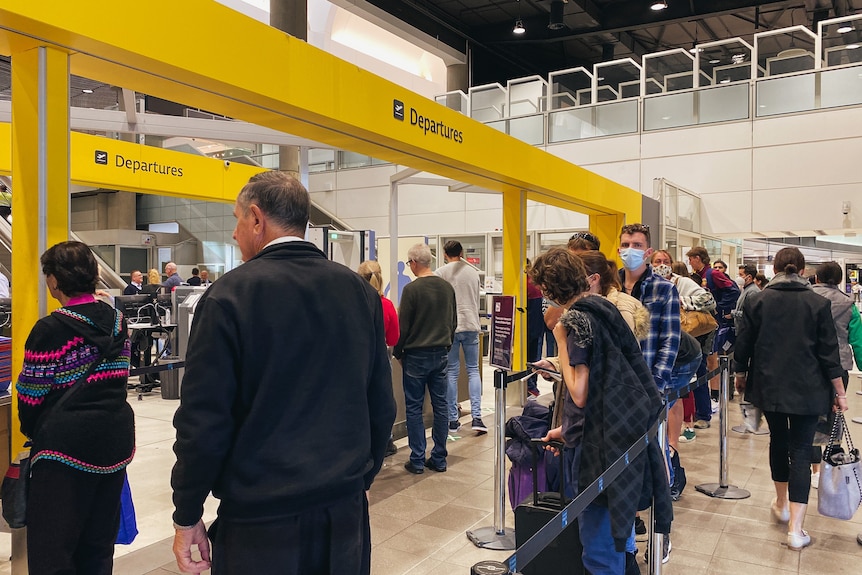 People lined up at security at Brisbane Airport on a busy day