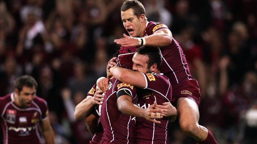 The Queensland players celebrates after scoring the opening try of State of Origin I