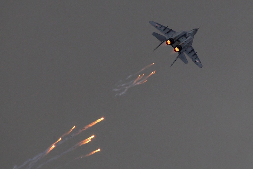  Polish Air Force MiG-29 aircraft fires flares during a performance at air show.
