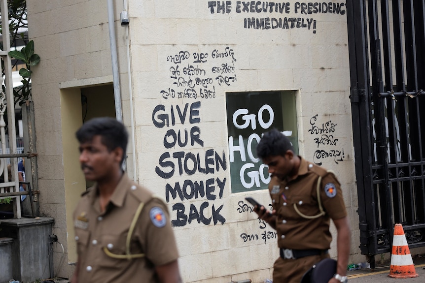 The room meant to house security guards has: 'give our stolen money back' painted on it 