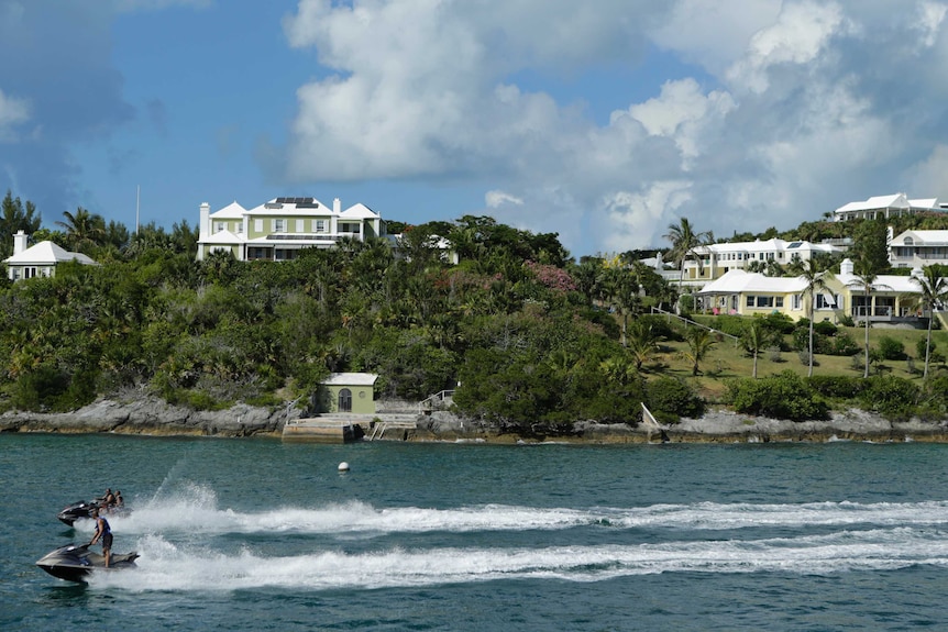 A pair of jet skiis race near the port of Hamilton in Bermuda.