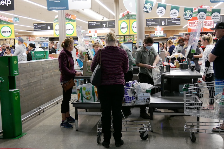 Shoppers line up at the check-out at Alice Springs Woolworths.