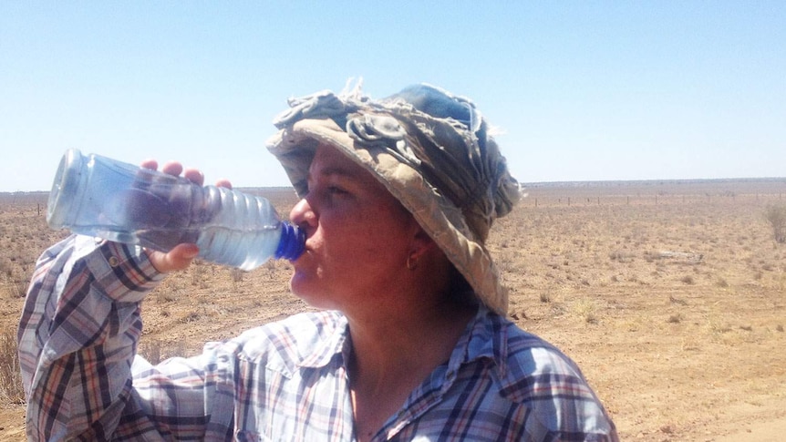 Grazier Anne Webber rehydrates amid the relentless heat on her Longreach property