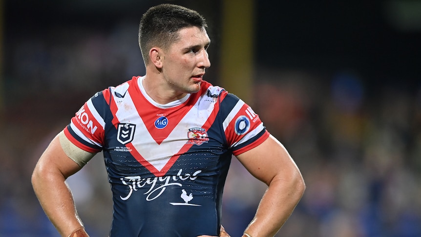 A Sydney Roosters NRL player stands with his hands on his hips after being placed on report.