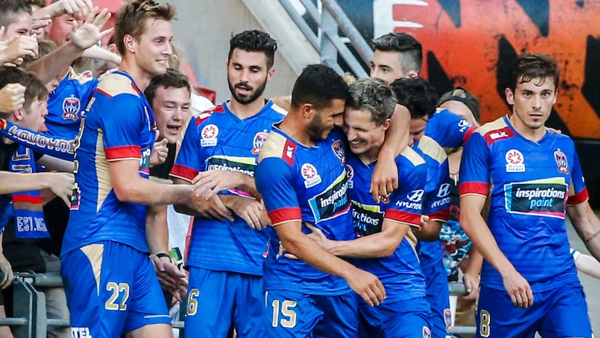 Newcastle Jets players celebrate goal against Roar