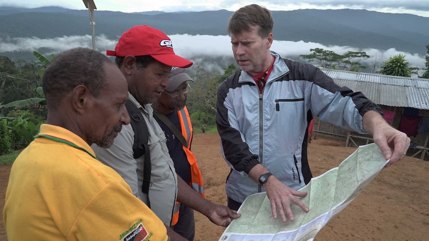 People look look at map in Naoro village.