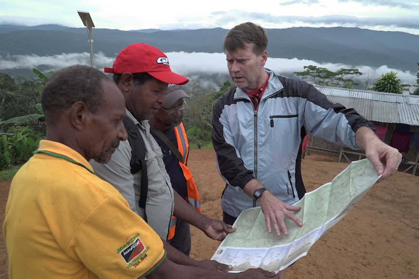 People look look at map in Naoro village.