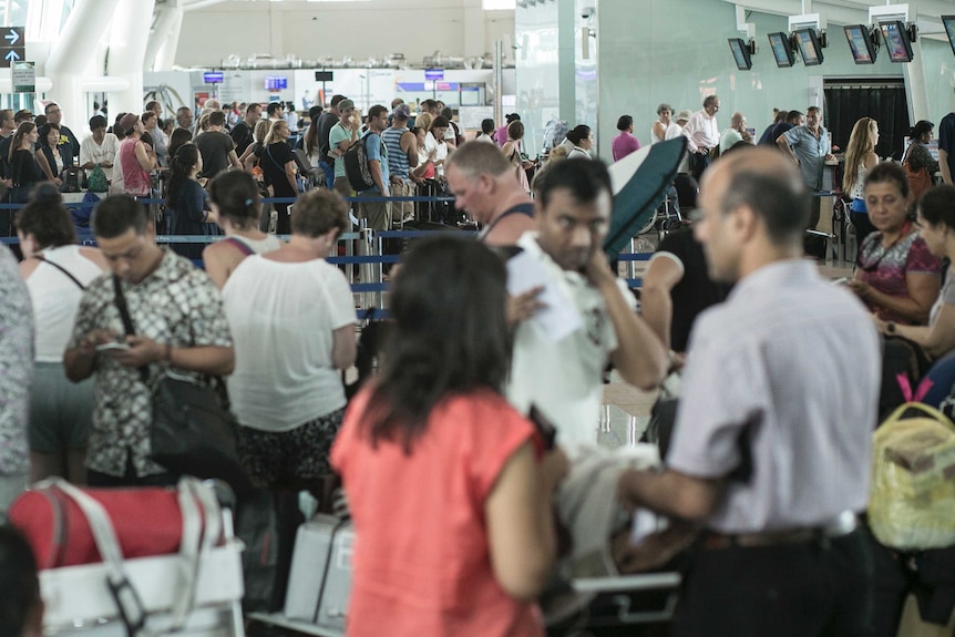 A crowd of people in an airport.