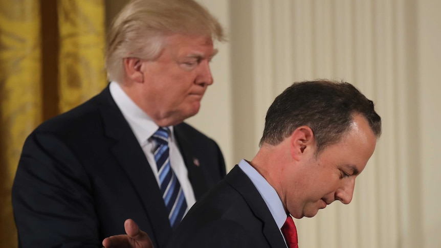 Donald Trump (left) pats his new chief of staff Reince Priebus on the back