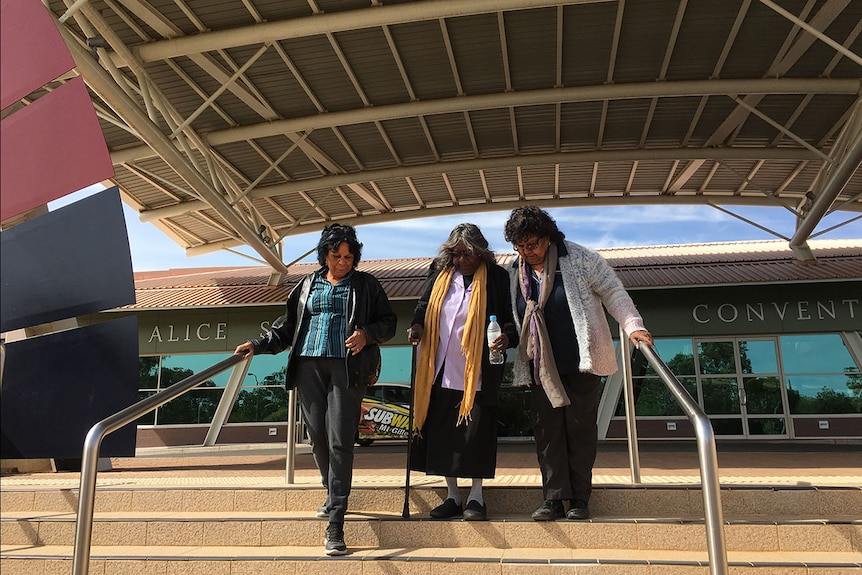Margaret Kemarre Turner (centre) leaves the Alice Springs Convention Centre