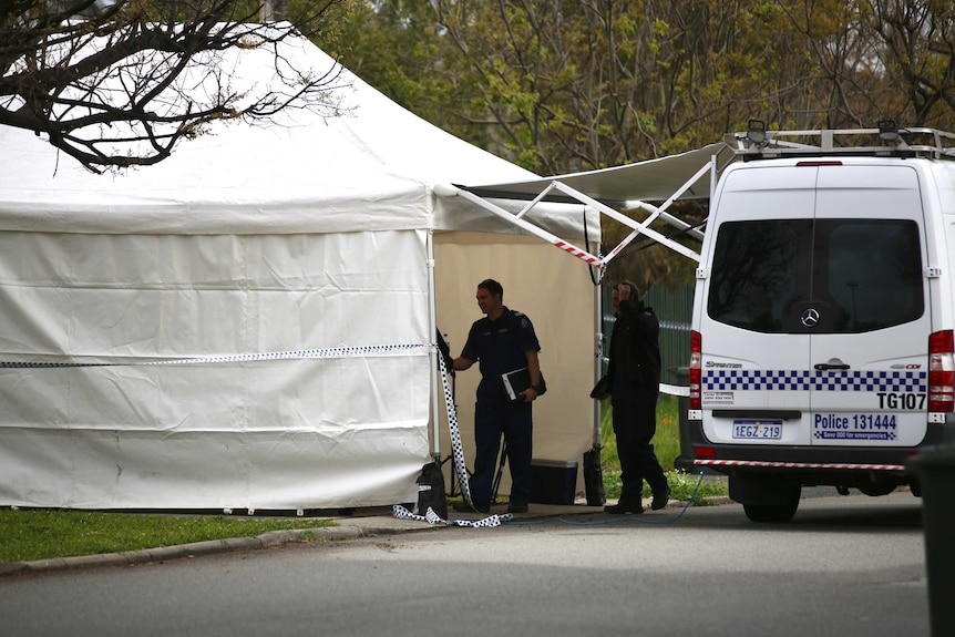 A white forensic tent in front of a property on a tree-lined street.