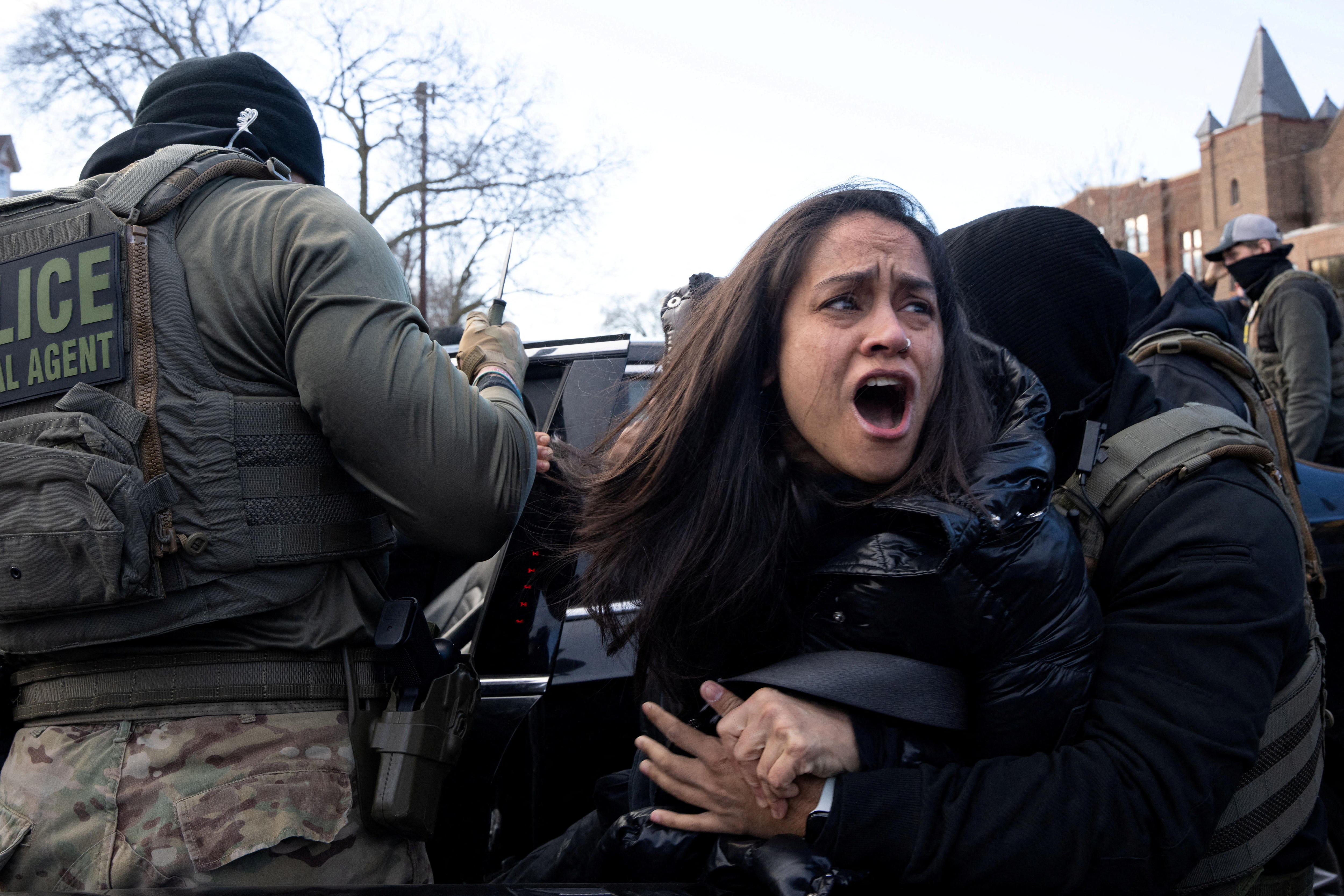 Aliya Rahman is pulled from her vehicle by masked federal agents as part of an immigration crackdown in Minnesota.