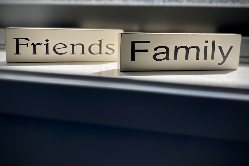 Decorative blocks with the words Friends and Family on a window sill.