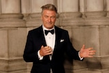  Actor Alec Baldwin gestures before walking on the red carpet.