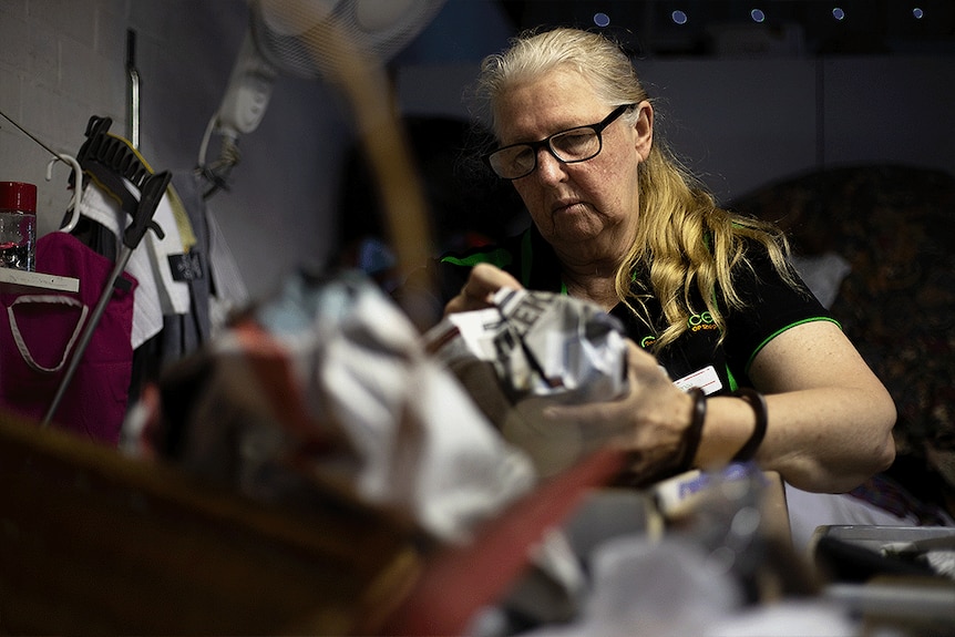 A female volunteer at 2nd Chance op shop working 