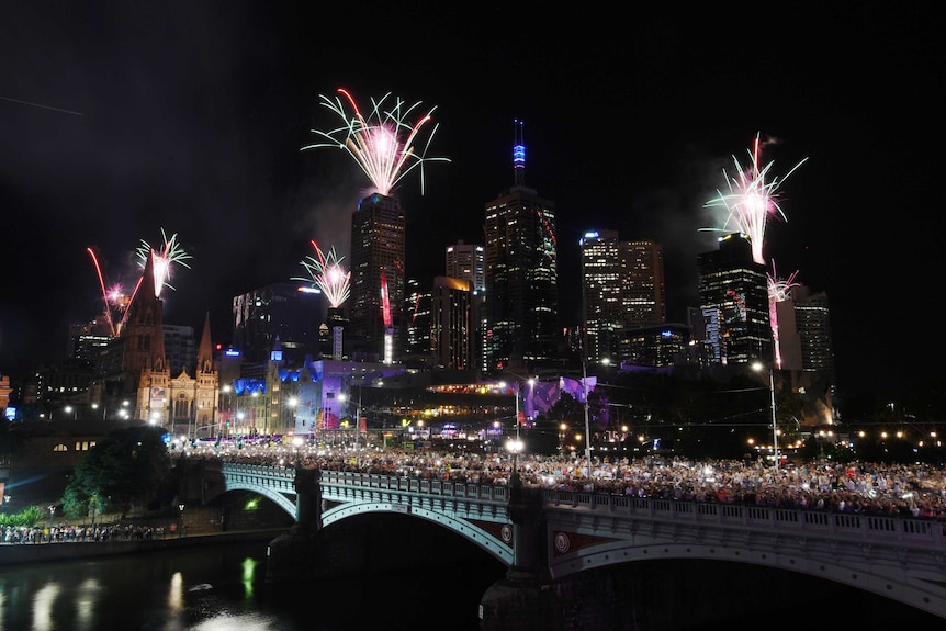 Fireworks explode over the Princes Bridge during in Melbourne at night