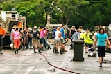 Volunteers clean-up a street at Fairfield after floodwaters subside