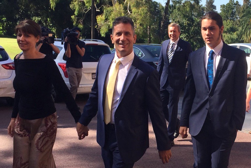 Paul Papalia walking with family members in a carpark.