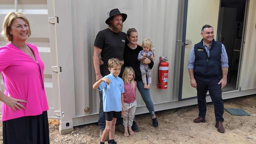 The Willis family standing out side their new 40-foot pod  pod with the Deputy Premier John Barilaro and Oxley MP Melinda Pavey