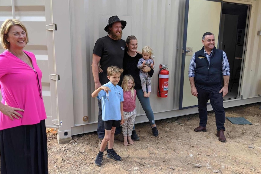 The Willis family standing out side their new 40-foot pod  pod with the Deputy Premier John Barilaro and Oxley MP Melinda Pavey