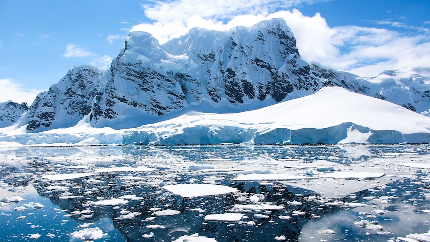 Snow-capped mountains touch the Southern Ocean