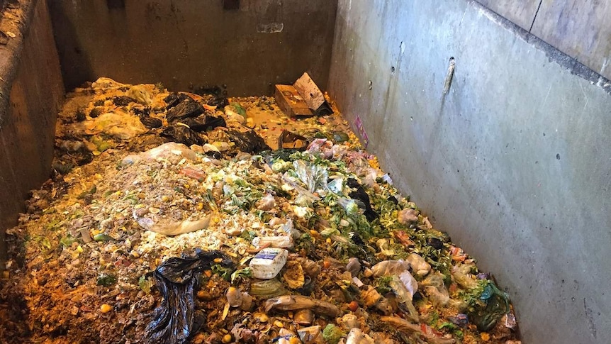 Tip of rotting food and plastic objects in a concrete bin at Earthpower in Camelia western Sydeny
