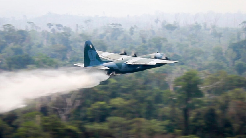 In this photo released by Brazil Ministry of Defense, a C-130 Hercules aircraft dumps water to fight fires burning in the Amazon rainforest, in Brazil, Saturday, Aug, 24, 2019. Backed by military aircraft, Brazilian troops on Saturday were deploying in the Amazon to fight fires that have swept the region and prompted anti-government protests as well as an international outcry. (Brazil Ministry of Defense via AP). Photo uploaded August 25, 2019.