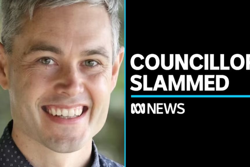 Councillor Slammed: Young man with grey hair smiles, posing for the camera