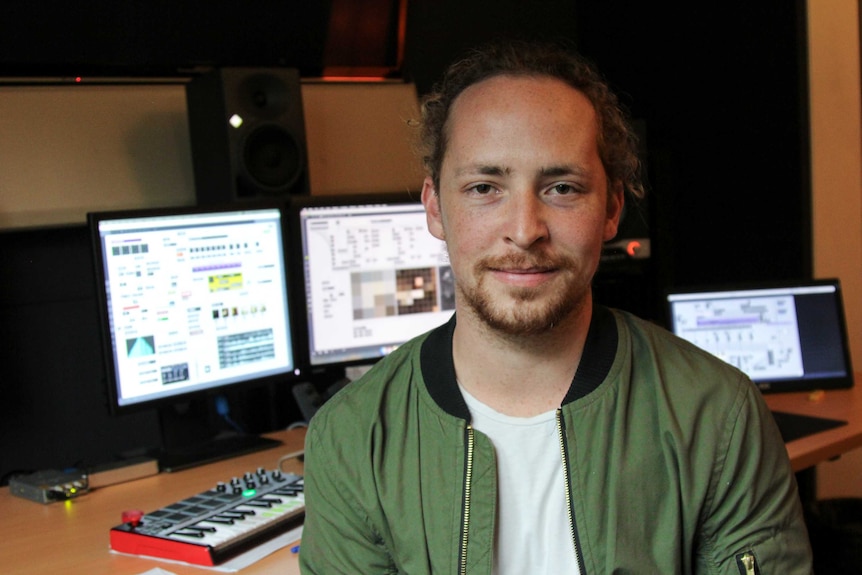 Audio engineer Julian Wessels smiling at the camera in his studio.