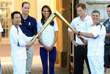 Prince William, Duchess of Cambridge and Prince Harry watch the Olympic Torch at Buckingham Palace.