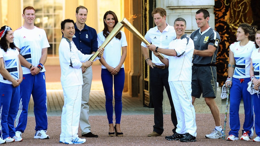 Prince William, Duchess of Cambridge and Prince Harry watch the Olympic Torch at Buckingham Palace.