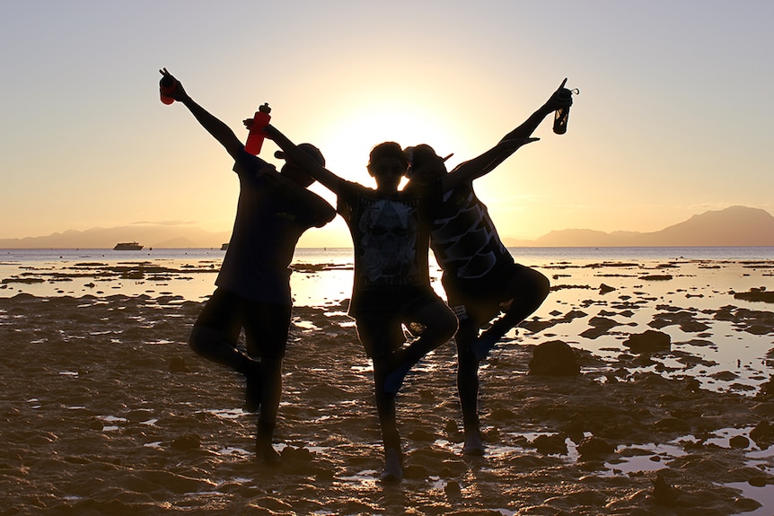 Three teenagers in the Orpheus Island sunset.
