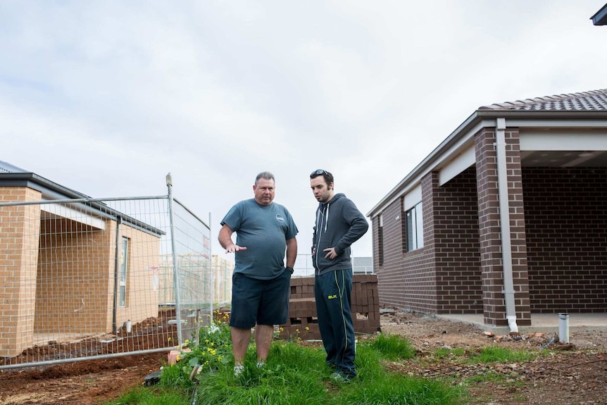 Matt discusses the back boundary fence with a neighbour.