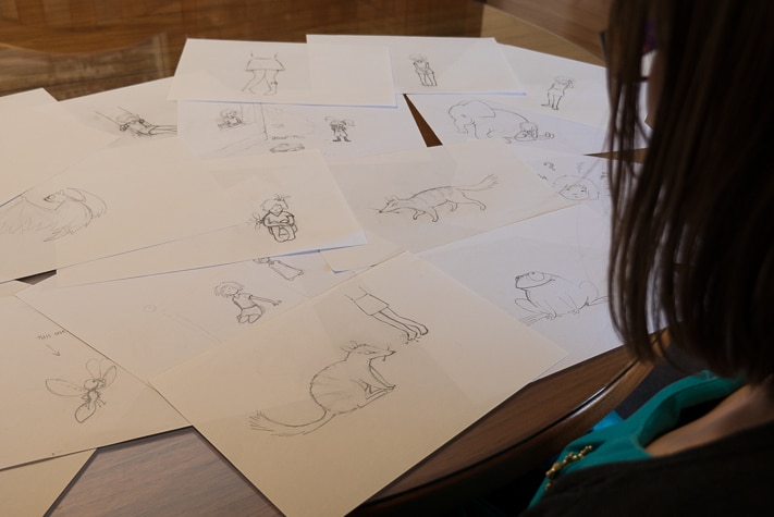 Megan Schartner looking over sketches for her book.