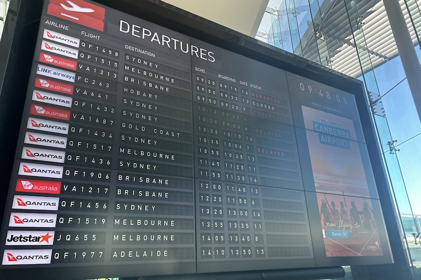 A departures board in an airport.