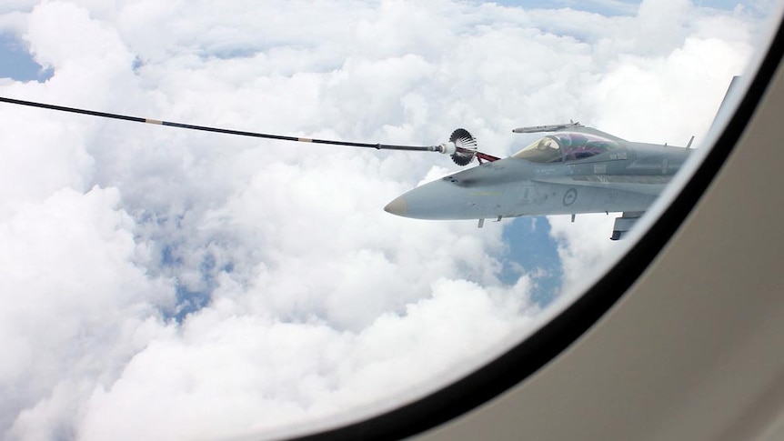 An RAAF F/A-18A takes fuel from a KC-30A.
