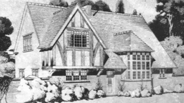 A black and white image of a Tudor style home