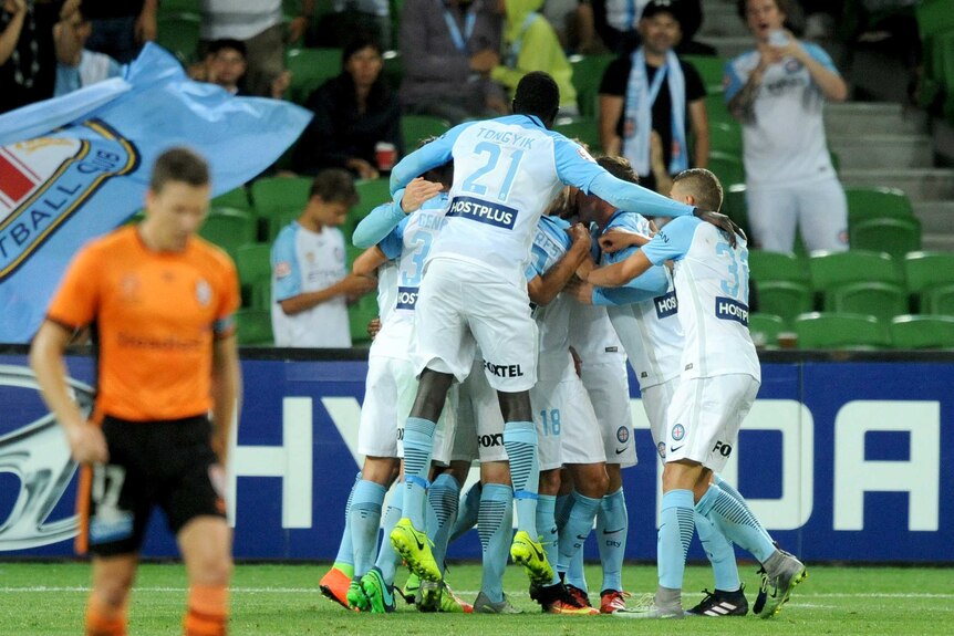 Melbourne City players celebrate a goal against the Roar