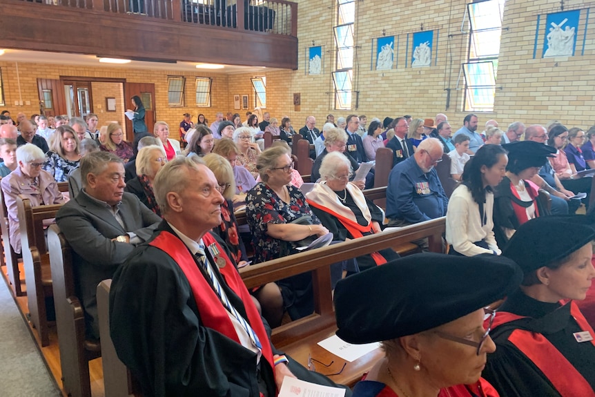 a crowd of dignitaries in a church