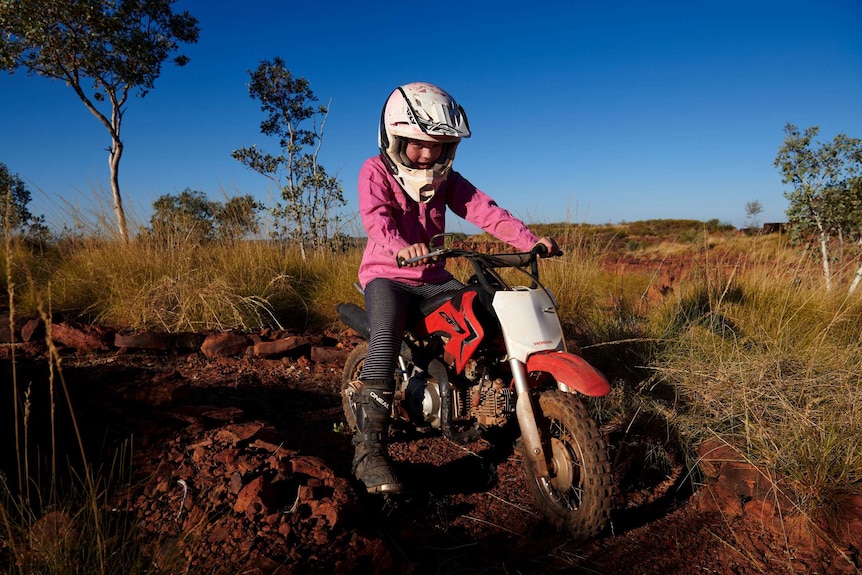 Matilda Sale rides her motorbike at the Yougawalla homestead