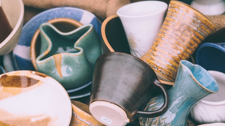 A box full of cups and kitchenware