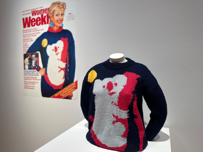 A sweater next to a cover of the Women's Weekly.