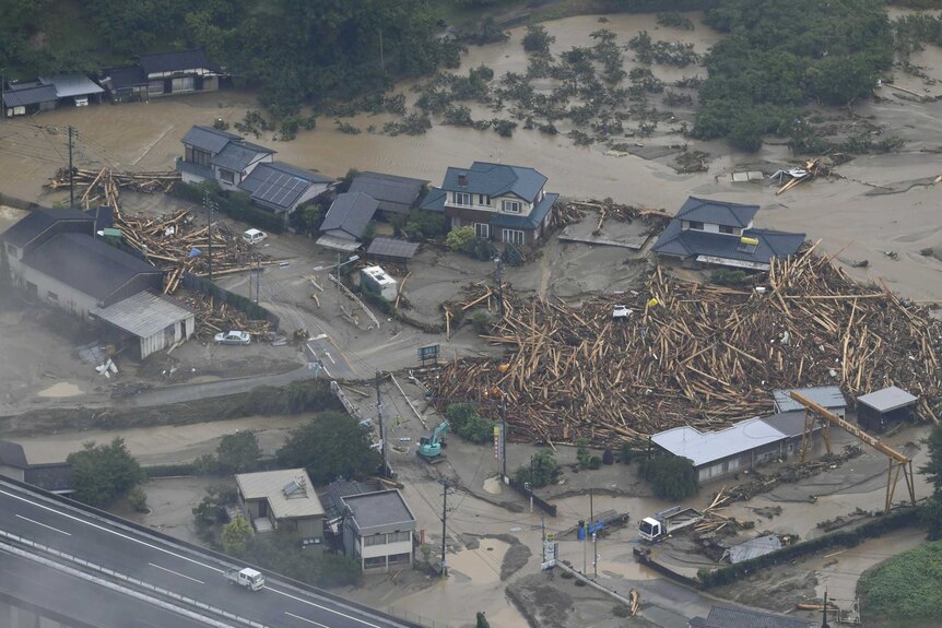 An aerial photo shows flood waters and mud engulfing houses.