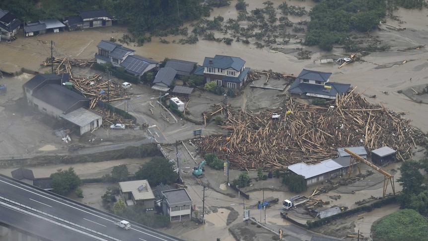 An aerial photo shows flood waters and mud engulfing houses.