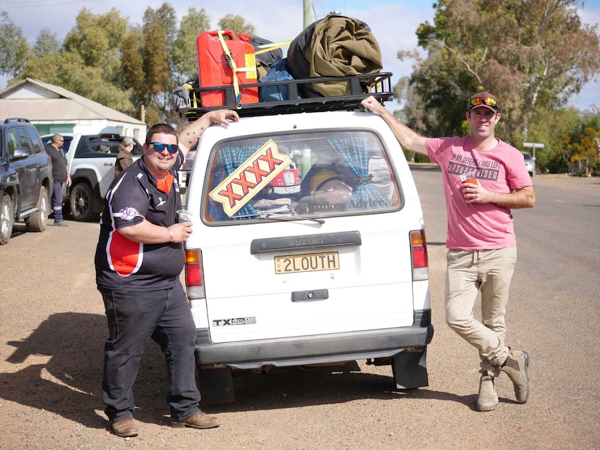 Two men stand on either side of a white van with the numberplate 2Louth. The van is packed with gear.