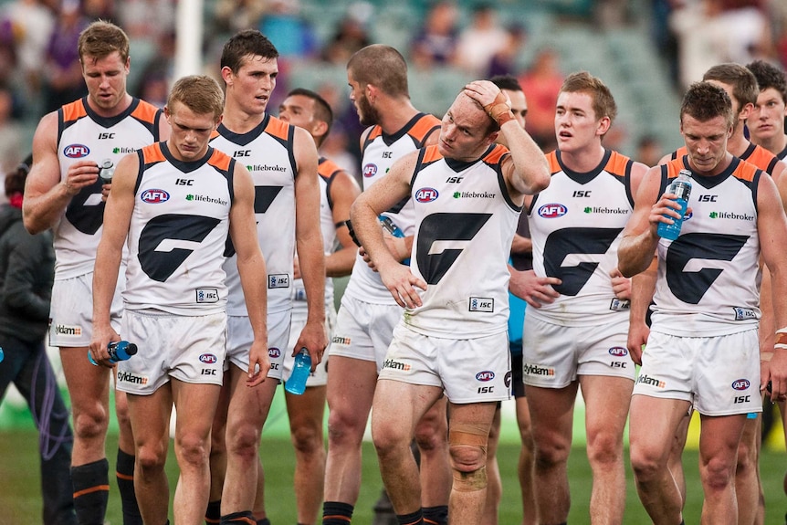 AFL team walks off the ground after another big defeat.