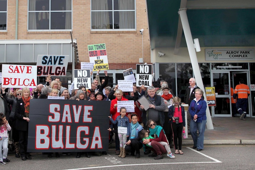 Residents of Bulga in NSW's Hunter Valley, and their supporters, demonstrating with placards.