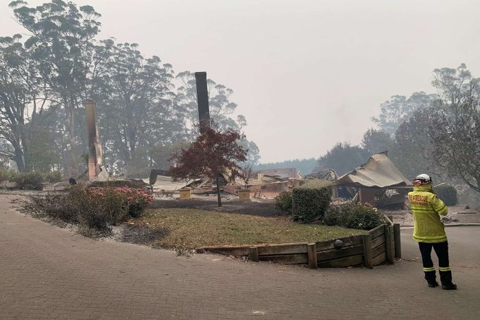 A razed home in a smoky haze.