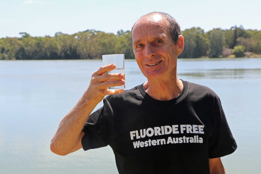 John Watt holding a glass of water.