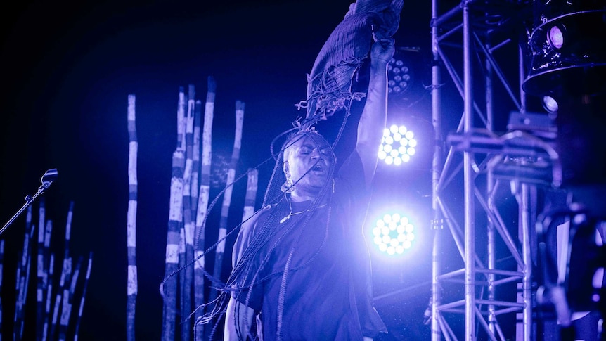 Colour photo of Zaachariaha Fielding of Electric Fields singing on stage at night time at Dance Rites 2018.